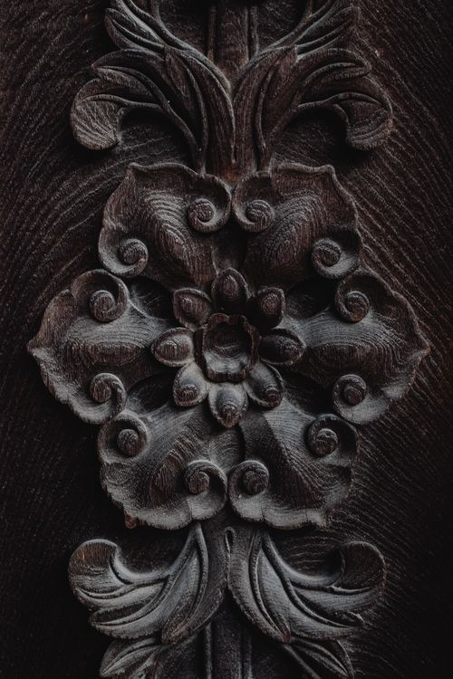 Free Close-up of a finely carved floral design on a wooden surface showcasing intricate craftsmanship. Stock Photo