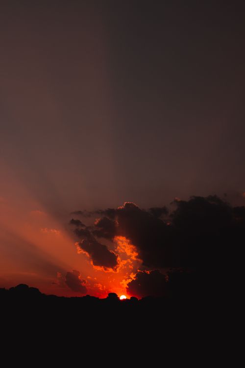 Free Beautiful sunset over Brazil with dark clouds and vibrant colors painting the sky. Stock Photo