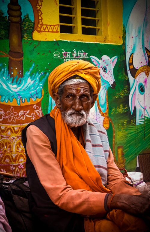 Free A vibrant portrait of an elderly Indian man in Barsana, India, wearing traditional clothes and a yellow turban. Stock Photo