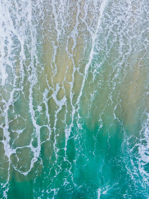 Top View of Turquoise Sea with Foam