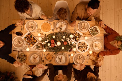 Free Top View of a Family Praying Before Christmas Dinner Stock Photo