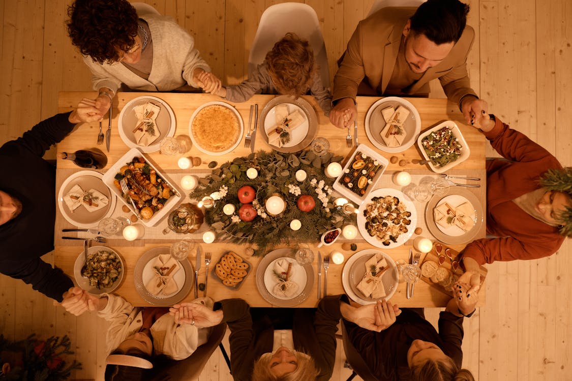 Top View of a Family Praying Before Christmas Dinner