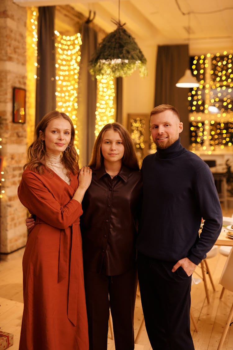 Family Smiling While Looking At The Camera