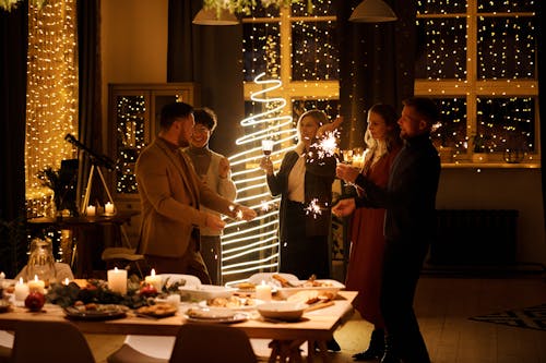 Free Family Celebrating Christmas While Holding Burning Sparklers Stock Photo