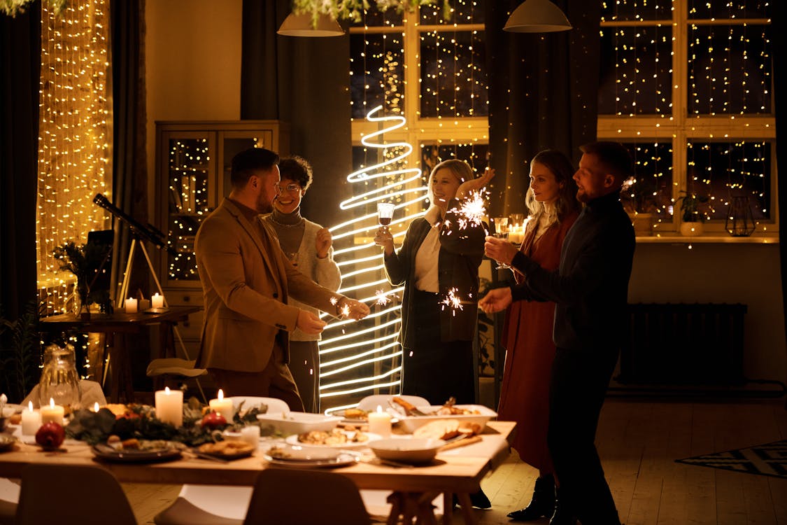 Family Celebrating Christmas While Holding Burning Sparklers