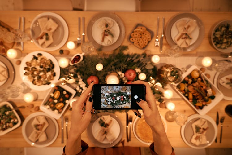 Top View Of A Person Taking Picture Of Christmas Dinner