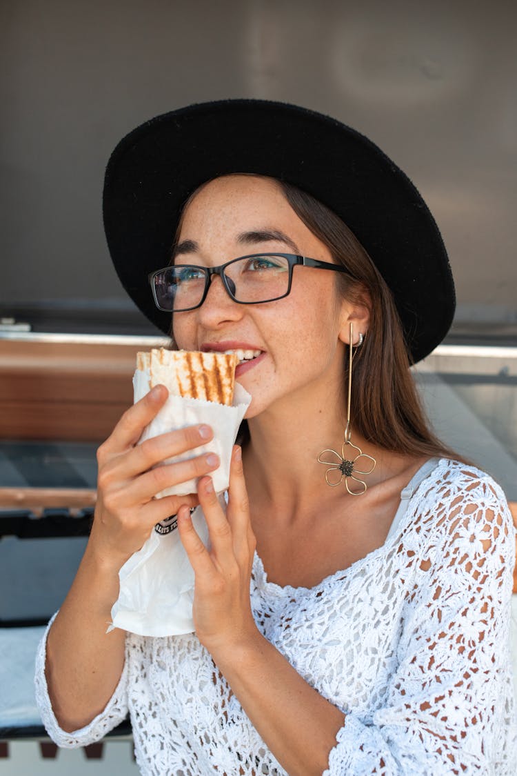 Woman In White Top Eating Shawarma