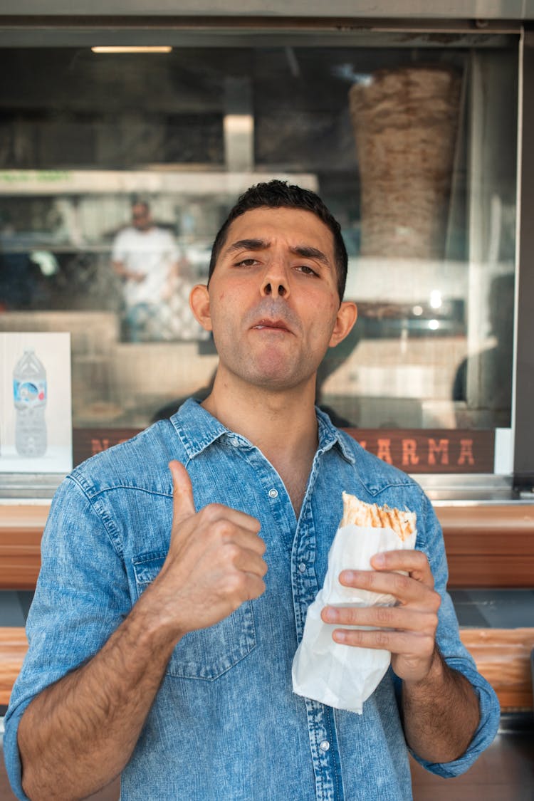 A Man Eating Shawarma