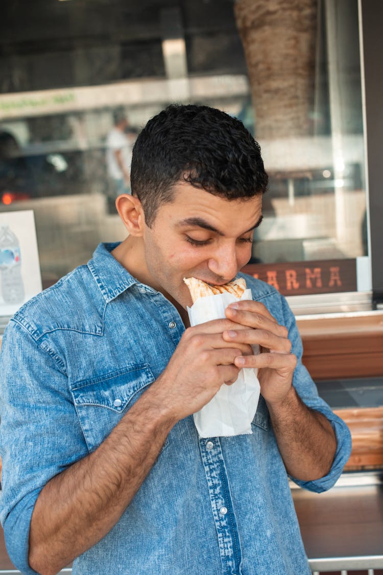 A Man Eating Shawarma