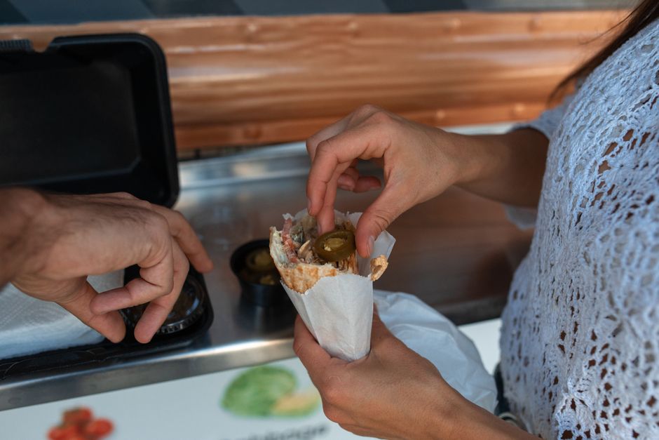 Close-up of a freshly made shawarma wrap with grilled meat and vegetables, a popular Dubai street food.
