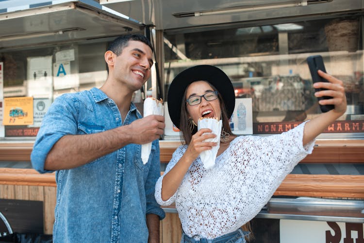 Friends Taking A Selfie While Eating Shawarma 