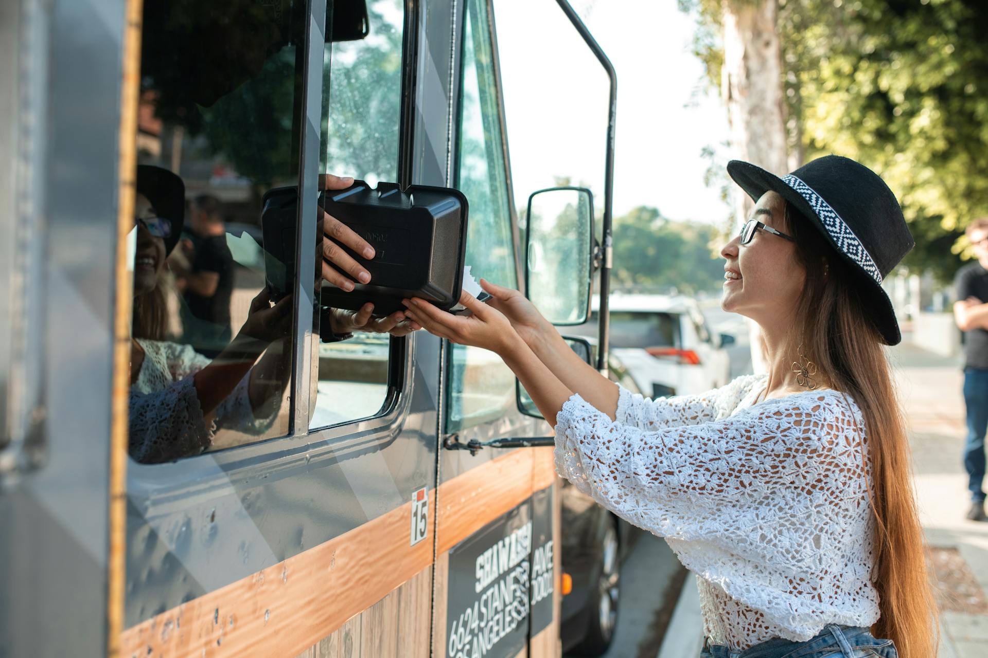 Woman receiving a Food Order from a Food Truck