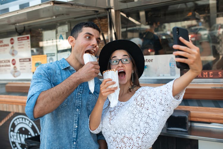 Friends Taking A Selfie While Eating Shawarma 