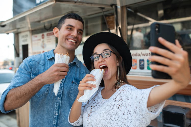 Friends Taking A Selfie While Eating Shawarma 