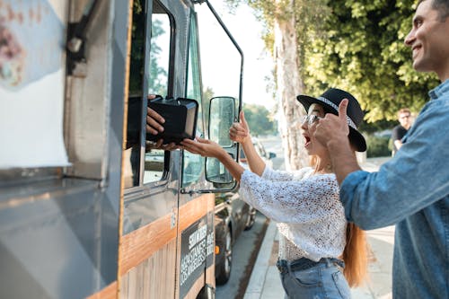 Free Happy Woman receiving a Food Order from a Food Truck Stock Photo