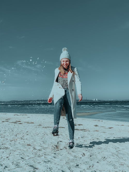 Cheerful woman on sandy beach