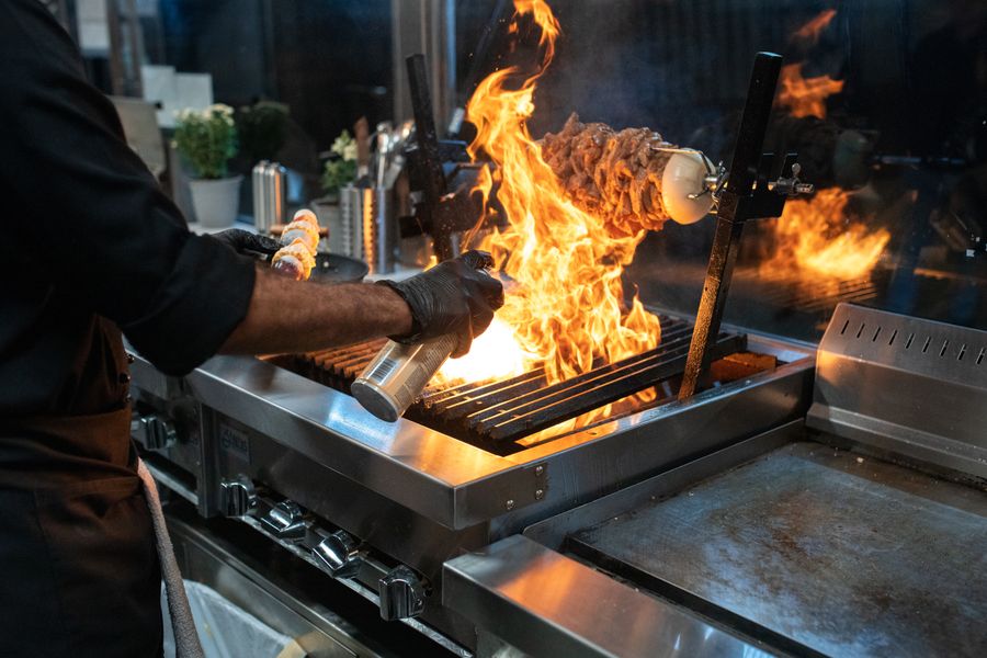Chef grilling with flames, photo by RDNE Stock project on Pexels