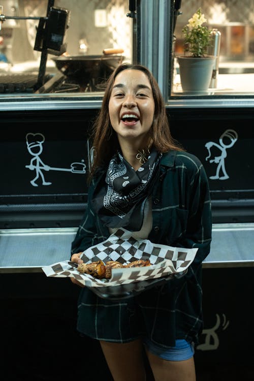 Free Happy Woman holding a Deliciously Prepared Street Food  Stock Photo