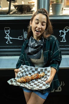 A joyful woman holding grilled skewers from a food truck. Perfect depiction of street food enjoyment.