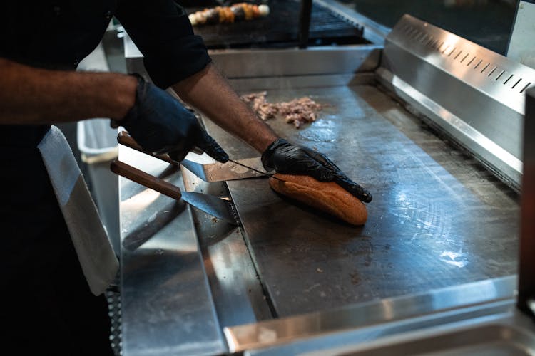 Slicing Of Sandwich On A Pan 