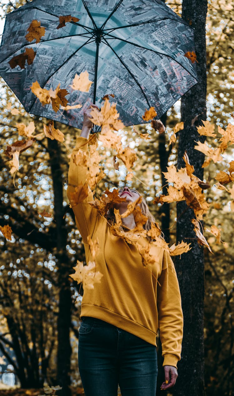 Woman In Yellow Sweater Holding Umbrella