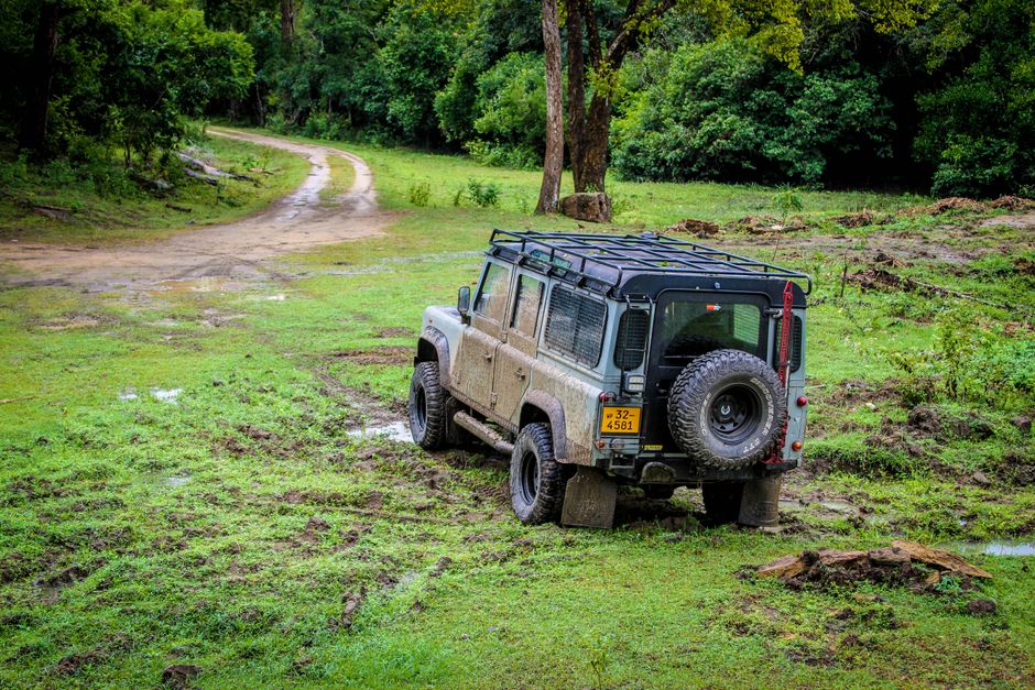 Explore the rugged trails of Sri Lanka with this off-road vehicle in a lush forest setting.