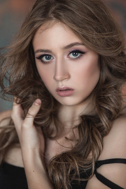 Portrait of a bare young woman with long, brown hair and natural make-up.  Stock Photo