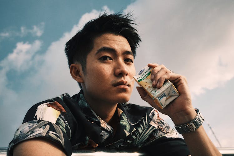 Young Ethnic Guy Drinking Juice Using Straw