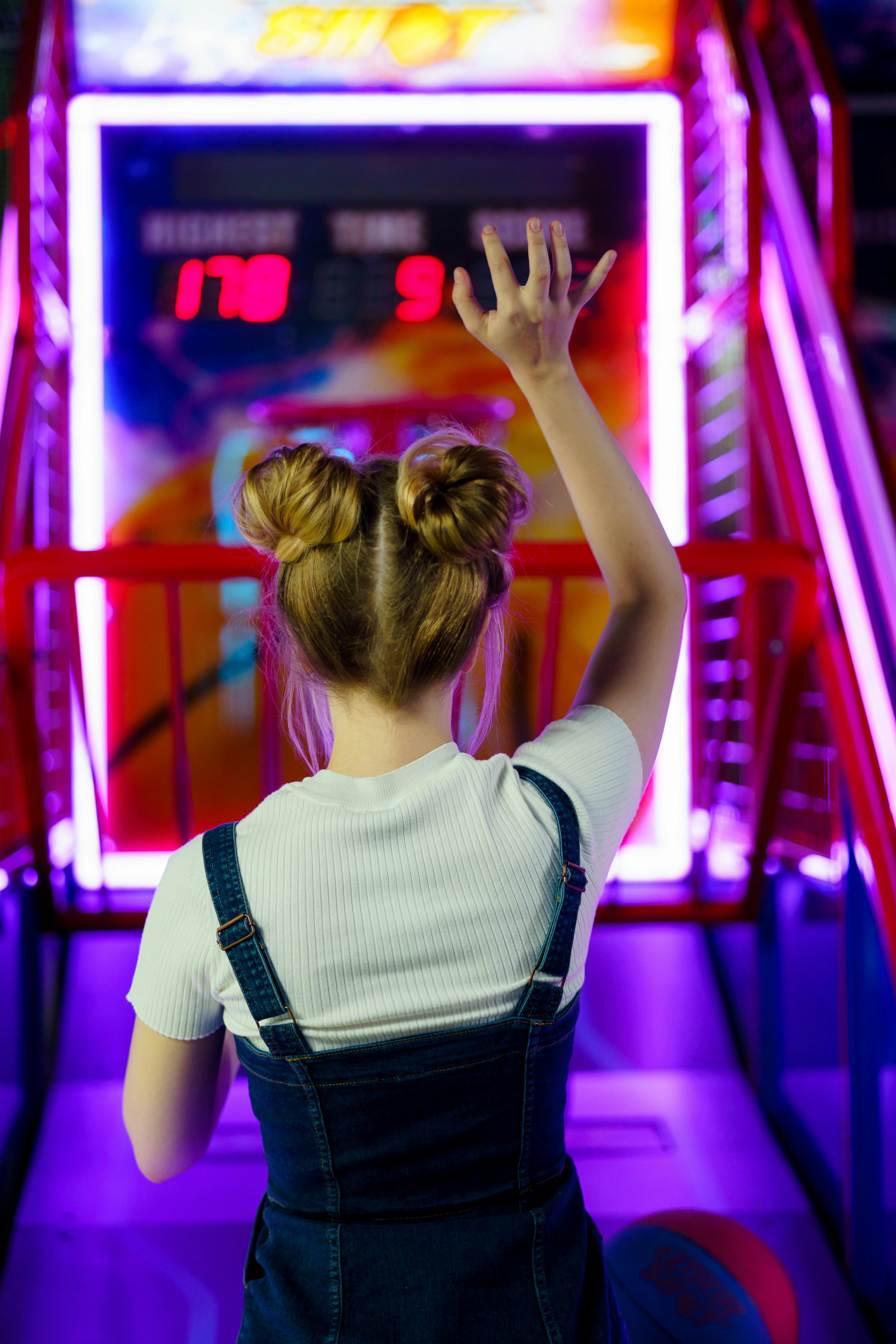 back view of a person playing basketball in an amusement center