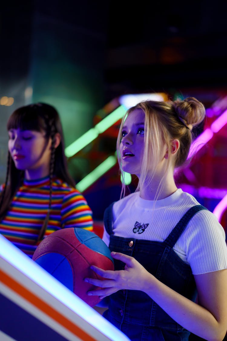 Friends Playing Basketball In An Amusement Center