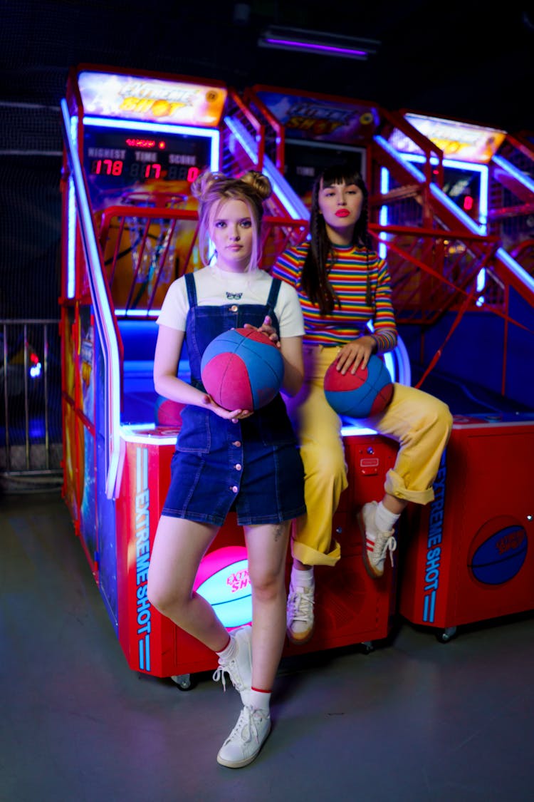 Women Holding Balls In An Amusement Center