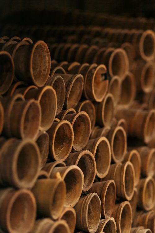 Free A detailed close-up shot of stacked rustic brown clay pots, artfully arranged. Stock Photo
