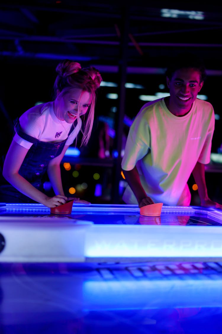 Two Friends Playing Air Hockey 