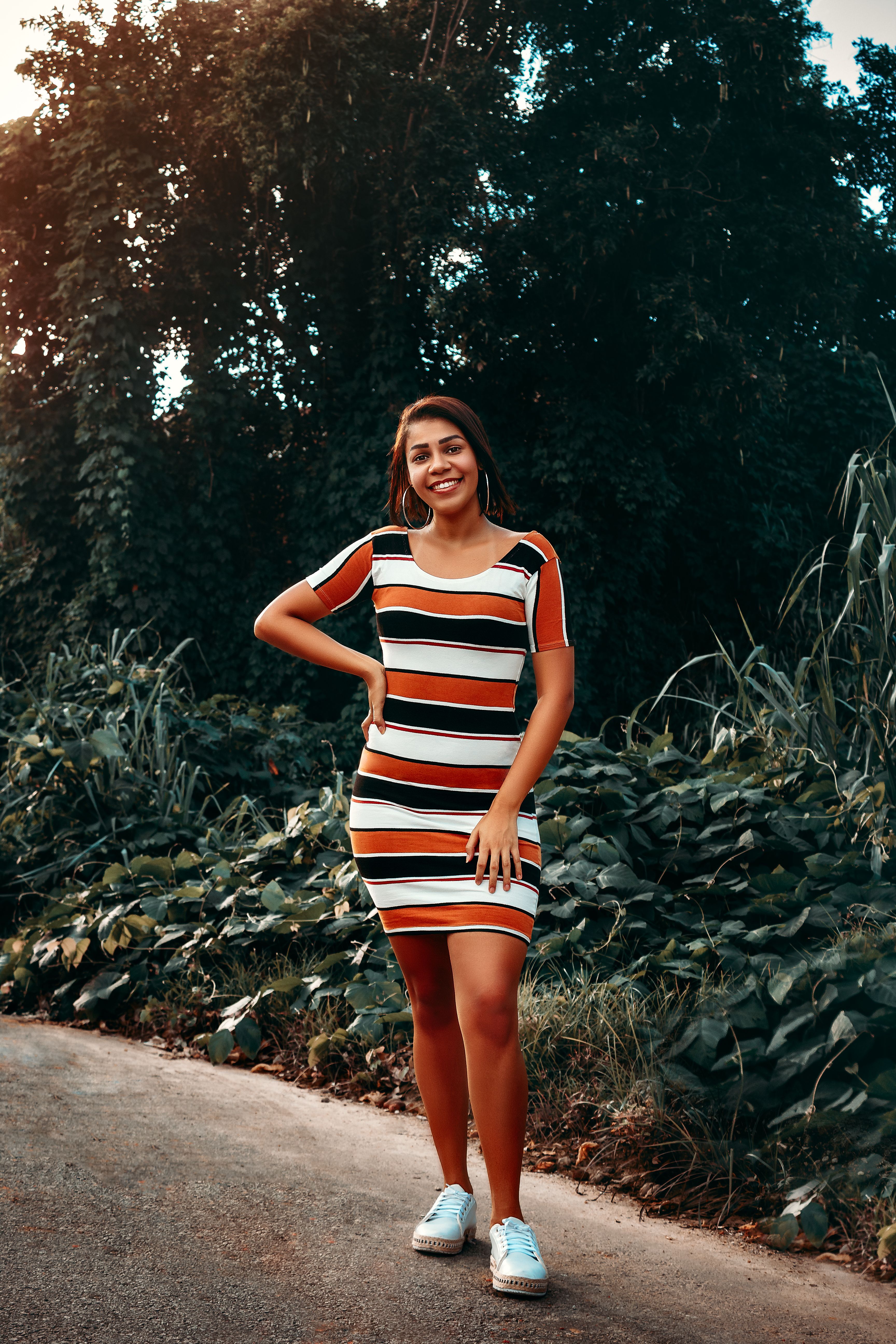A Portrait of a Woman in a Striped Dress · Free Stock Photo