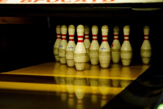 Close-up of arranged bowling pins on a lane, ready for a strike.