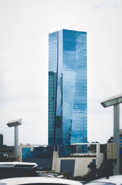 Free High rise skyscraper with glass walls located in city downtown on cloudy day Stock Photo