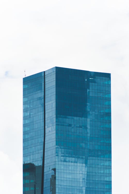 Free Contemporary glass skyscraper in urban district Stock Photo