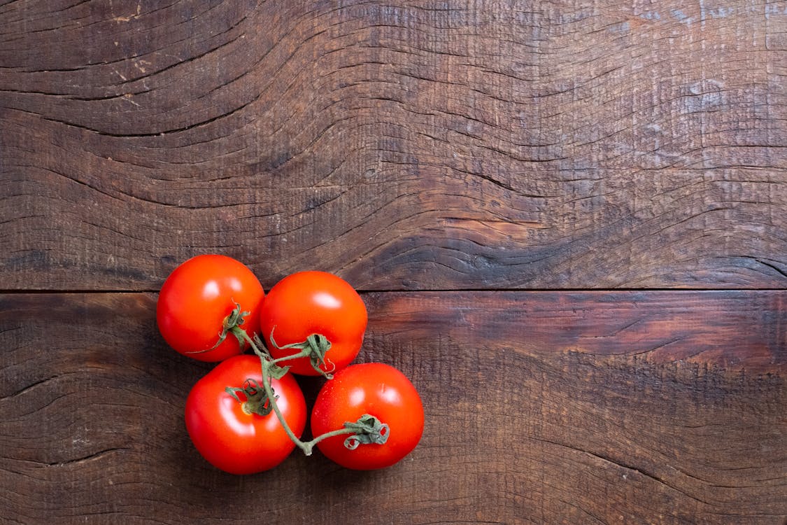 Red Tomatoes on Brown Wooden Table