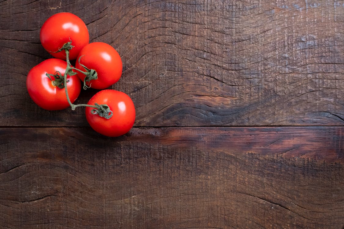 Red Tomatoes on Brown Wooden Table