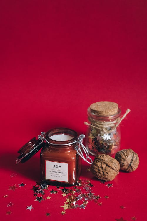 Scented Candle on a Red Glass Jar on a Red Surface