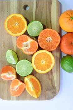 Vibrant citrus fruits, including oranges and limes, on a cutting board showcasing freshness and healthy eating.