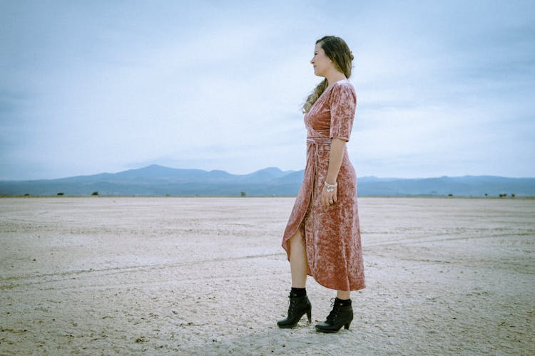 Woman Wearing A Velvet Dress And Black Boots