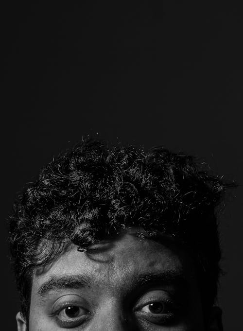 Grayscale Photo of Man's Curly Hair