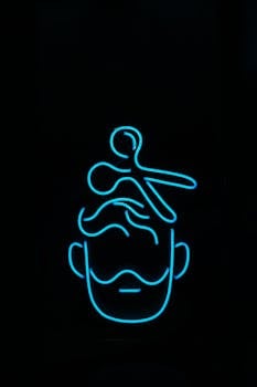 Illuminated neon sign of a barber with stylized scissors and a beard. Perfect for salon themes.