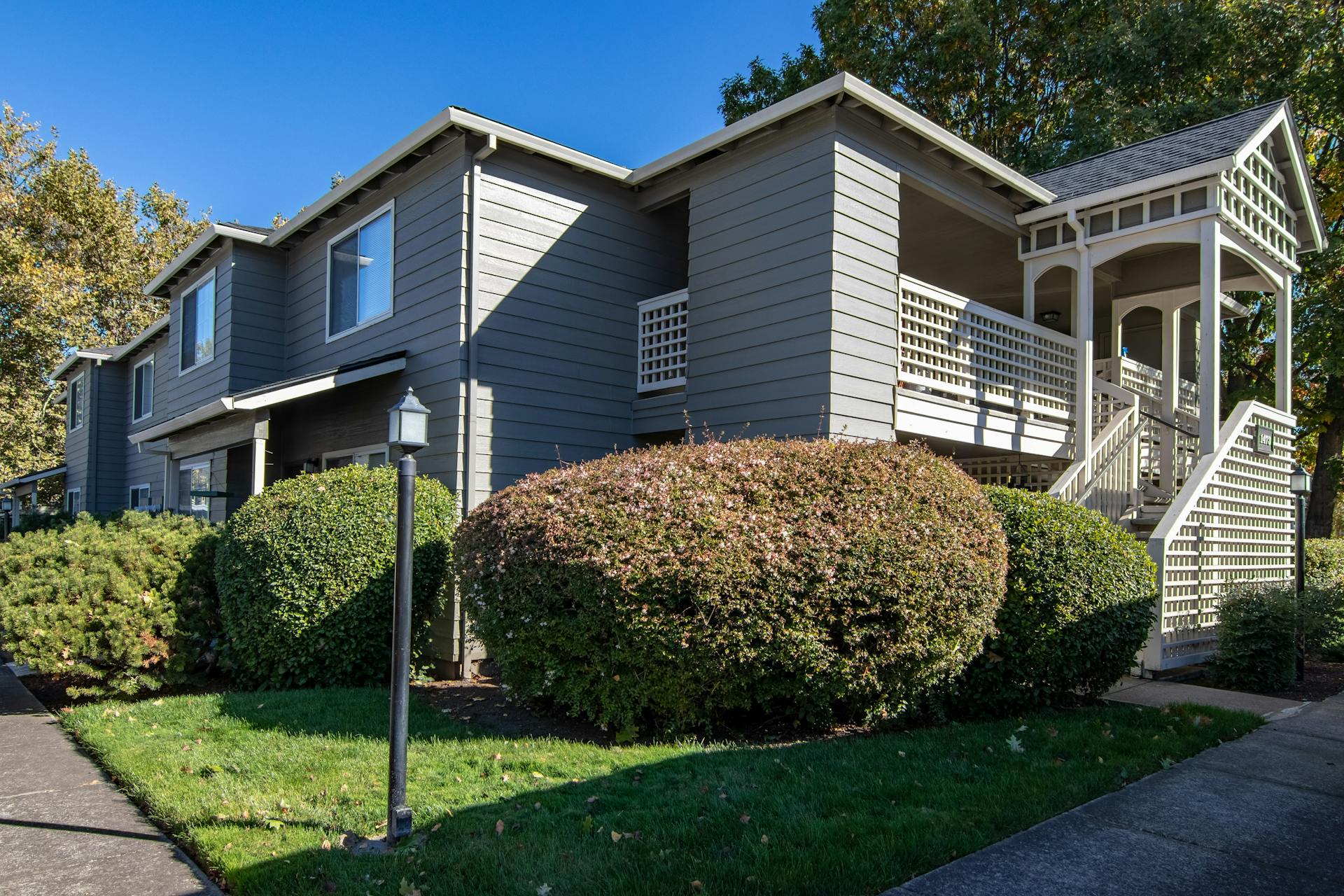 Modern residential building with lush landscaping in Medford, Oregon. Ideal for real estate or architecture themes.