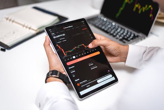 Professional analyzing cryptocurrency market data on a digital tablet with financial graphs.