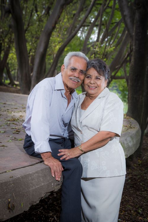 Free Heartwarming portrait of a senior couple smiling and embracing outdoors. Stock Photo