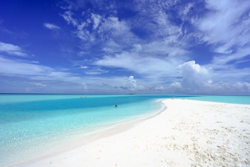 White Sand Beach Under Blue Sky