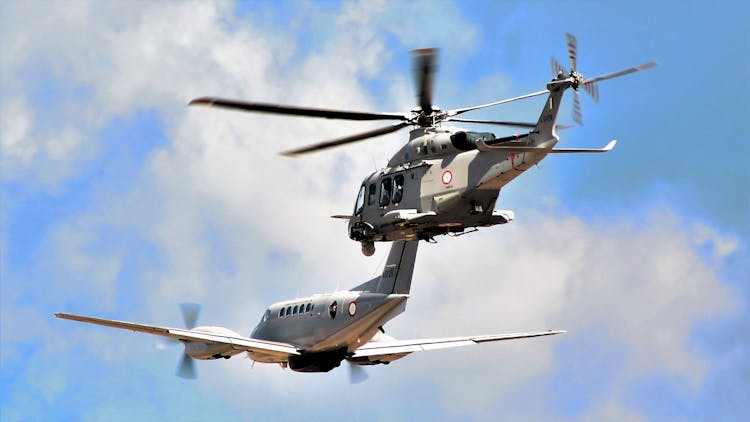 Helicopter And Airplane Flying In Formation