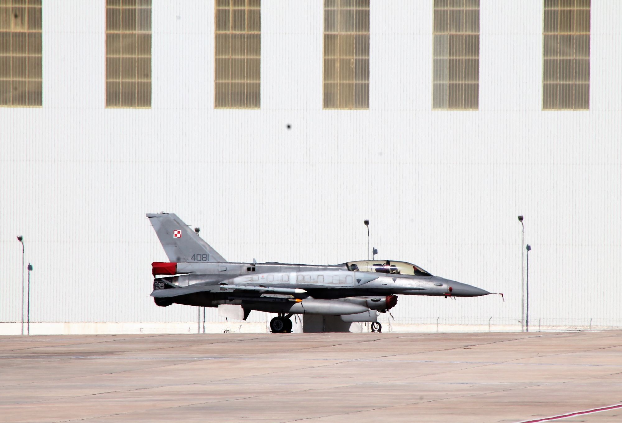 A Polish Air Force F-16 fighter jet parked outside a hangar in Luqa, Malta.